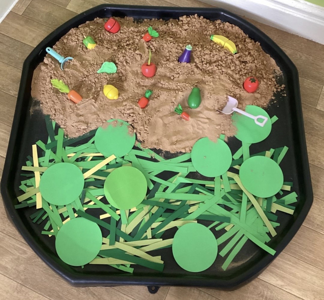 Sensory garden tuff tray with vegetables and sand